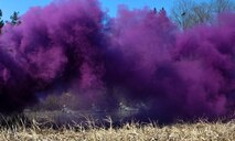 U.S. Air Force 8th Security Forces Squadron members take cover while purple smoke signals an attack during a field training exercise at Kunsan Air Base, Republic of Korea, March 17, 2017. Opposing forces attack the security forces members to test their teamwork and communication skills under stressful situations. (U.S. Air Force photo by Senior Airman Colville McFee/Released)