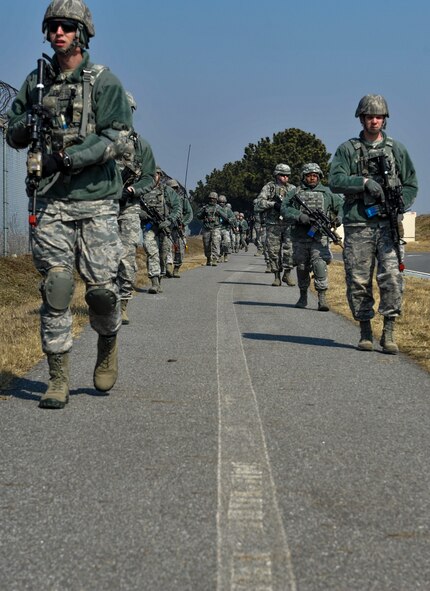 U.S. Air Force 8th Security Forces Squadron members march in a tactical staggered formation while observing their surroundings during a field training exercise at Kunsan Air Base, Republic of Korea, March 17, 2017. Tactical movements allow for military members to scan effectively and keep a safe distance between each other. (U.S. Air Force photo by Senior Airman Colville McFee/Released)