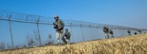 U.S. Air Force 8th Security Forces Squadron members, march in a tactical staggered formation while observing their surroundings during a field training exercise at Kunsan Air Base, Republic of Korea, March 17, 2017. U.S. Airmen work side by side to integrate air and ground operations more effectively in order to deter aggression in the region. (U.S. Air Force photo by Senior Airman Colville McFee/Released)