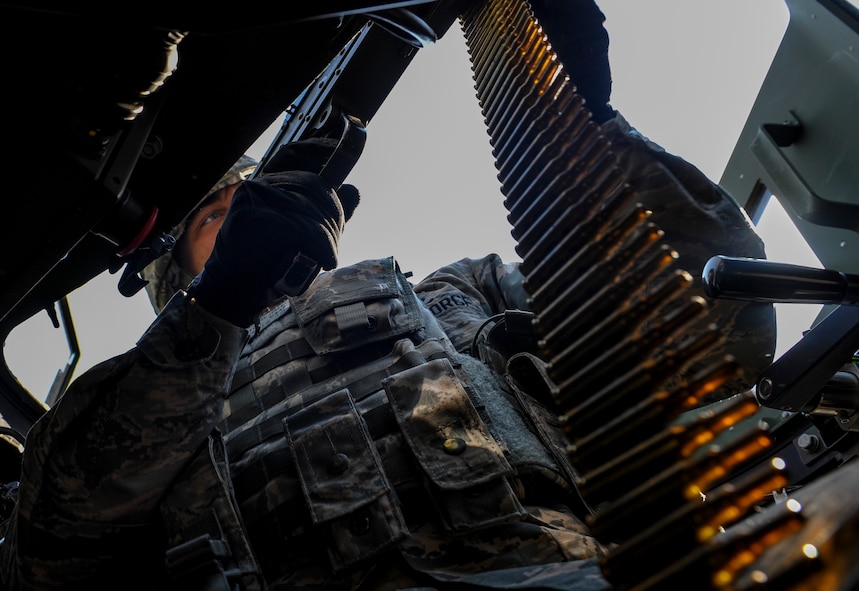 U.S. Air Force Airman 1st Class Jeremy Parnell, 8th Security Forces Squadron member, fires his M- 249mm Squad Automatic Weapon from the cover of his turret during a field training exercise at Kunsan Air Base, Republic of Korea, March 17, 2017. Opposing forces attack the security forces members to test their team work and communication skills under stressful situations. (U.S. Air Force photo by Senior Airman Colville McFee/Released)