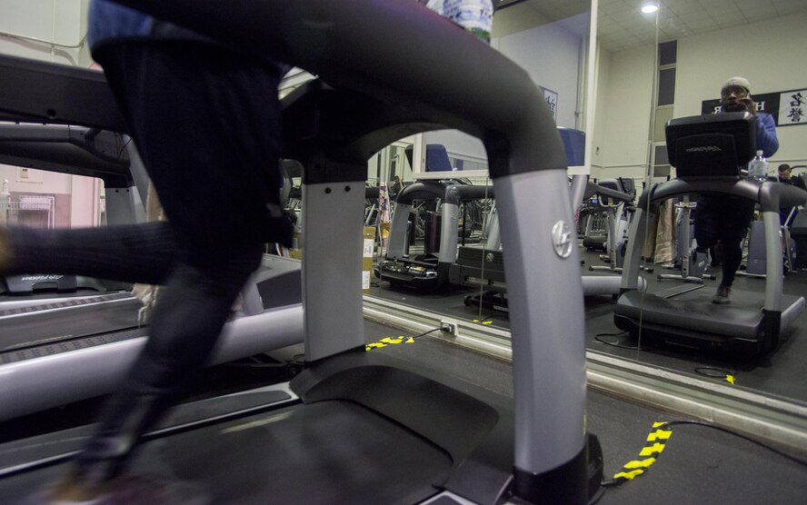 Staff Sgt. Dustin Payne, 374th Airlift Wing public affairs broadcast craftsman, runs on a treadmill in preparation for his amateur kickboxing debut at Yokota Air Base, Japan, Mar. 13, 2017. To be eligible to compete, Payne lost nearly 40 lbs. through running, sauna sessions and dieting. (U.S. Air Force photo by Senior Airman David C. Danford)