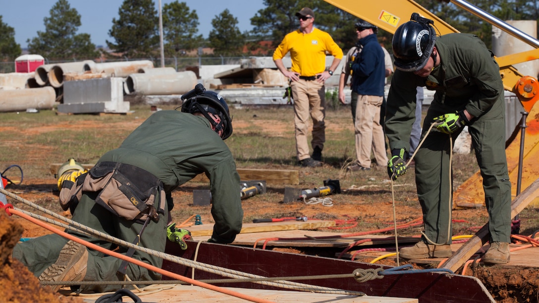 Cpl. Alexander Sutter, left, and Cpl. Vincent Leon, both Marines with Chemical Biological Incident Response Force, fix plywood into a 12-foot trench at Guardian Centers in Perry, Ga., March 20, 2017, during Exercise Scarlet Response 2017. The exercise, which goes from March 20 – 25, is the largest annual event for CBIRF, and it tests the unit’s capabilities to react and respond to threats and disasters such as nuclear detonations.