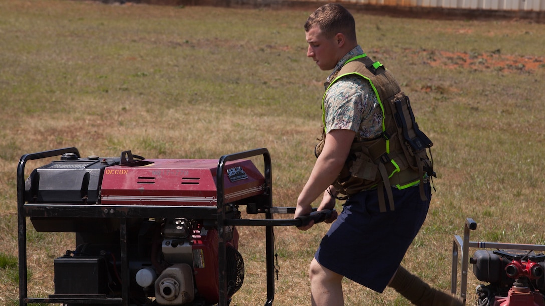 Lance Cpl. John Huss, a Marine with Chemical Biological Incident Response Force, prepares a water pump generator for a decontamination drill at Guardian Centers in Perry, Ga., March 20, 2017, during Exercise Scarlet Response 2017. During the drill, Marines were put in a scenario where they had limited amount of time to set up a decontamination tents for victims. The exercise, which goes from March 20 – 25, is the largest annual event for CBIRF, and it tests the unit’s capabilities to react and respond to threats and disasters such as nuclear detonations.