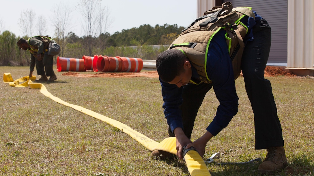 Lance Cpl. Milton Torres, a Marine with Chemical Biological Incident Response Force, prepares a hose for a decontamination drill at Guardian Centers in Perry, Ga., March 20, 2017, during Exercise Scarlet Response 2017.  The exercise, which goes from March 20 – 25, is the largest annual event for CBIRF, and it tests the unit’s capabilities to react and respond to threats and disasters such as nuclear detonations.