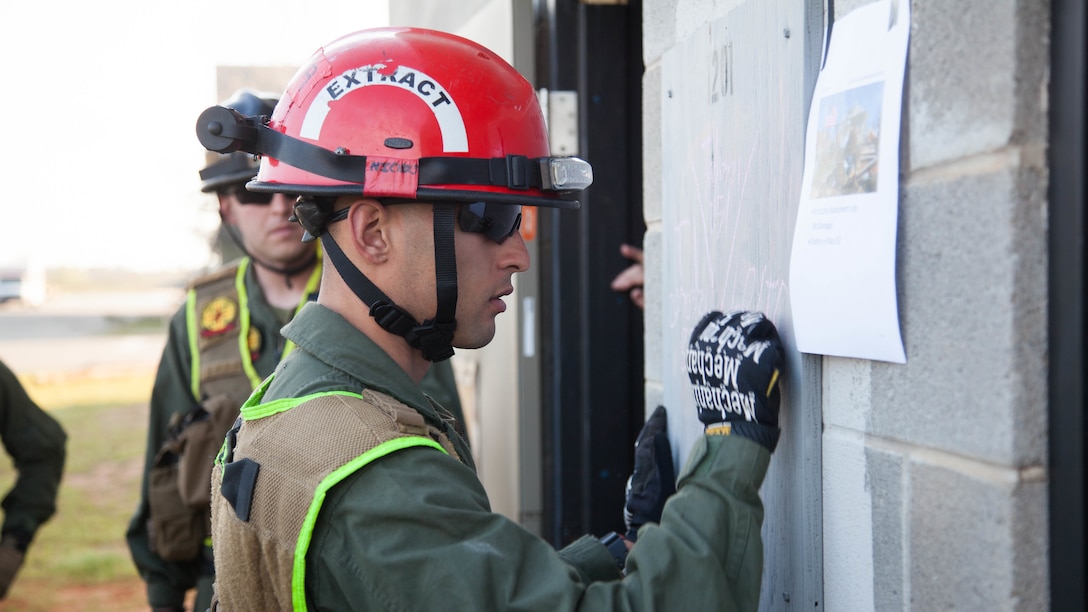 Lance Cpl. Carter Nichols, a Marine with Chemical Biological Incident Response Force, writes on a collapsed building at Guardian Centers in Perry, Ga., March 21, 2017, during Exercise Scarlet Response 2017. The Marines search through the building to annotate damage and extract any victims in the building. The exercise, which goes from March 20 – 25, is the largest annual event for CBIRF, and it tests the unit’s capabilities to react and respond to threats and disasters such as nuclear detonations.
