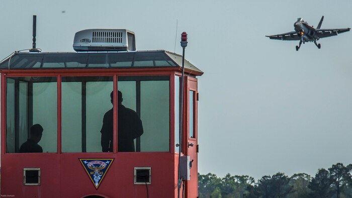 Landing signal officers communicate with a pilot preparing to land on a simulated aircraft carrier aboard Marine Corps Air Station Beaufort, March 22, 2017. The LSOs analyze the glide slope path and the movement of the carrier to decide whether the aircraft can land. The LSOs are with Marine Fighter Attack Squadron 312, Marine Aircraft Group 31.