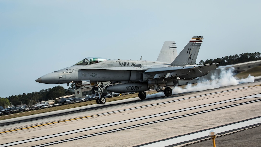 An F/A-18C Hornet aircraft conducts a simulated aircraft carrier landing aboard Marine Corps Air Station Beaufort, March 22, 2017. The runway is equipped with a painted outline simulating the carrier for the pilots. The Marine and aircraft are with Marine Fighter Attack Squadron 312, Marine Aircraft Group 31.