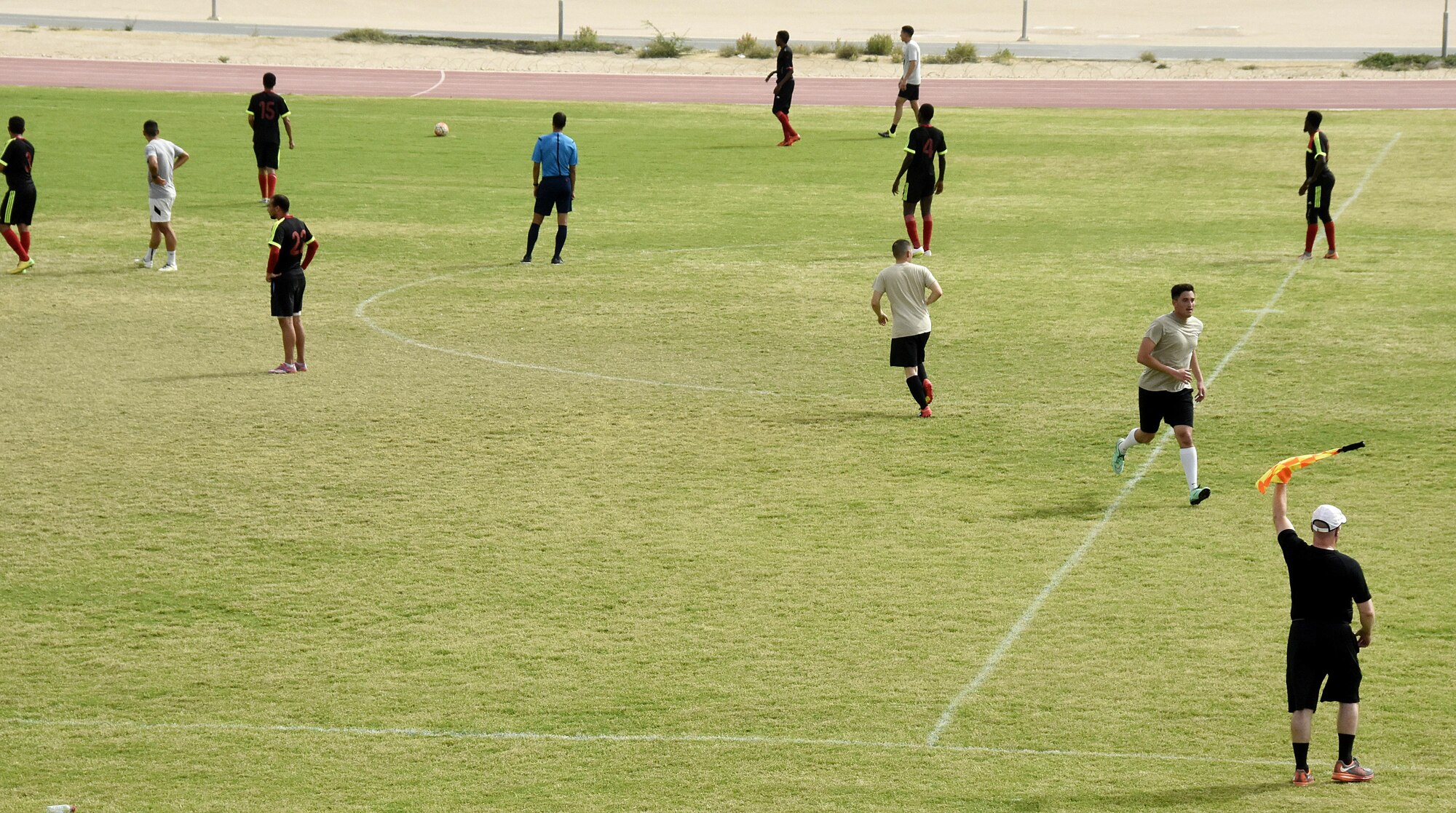U.S. Air Force Airmen with the 379th Expeditionary Security Forces Squadron play soccer with Qatar Emiri Air Force Security Forces members at Al Udeid Air Base, Qatar, March 23, 2017. The Airmen participated in a friendly game of soccer held to give members a chance to interact with their host nation partners. (U.S. Air Force photo by Senior Airman Cynthia A. Innocenti)