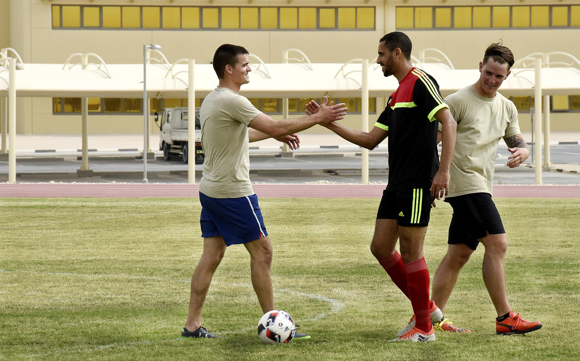 U.S. Air Force Airmen with the 379th Expeditionary Security Forces Squadron shake hands with Qatar Emiri Air Force Security Forces members after a soccer game at Al Udeid Air Base, Qatar, March 23, 2017. The Airmen who participated in the game and those who went to support their team had the chance to interact with their host nation counterparts during the friendly match. (U.S. Air Force photo by Senior Airman Cynthia A. Innocenti)