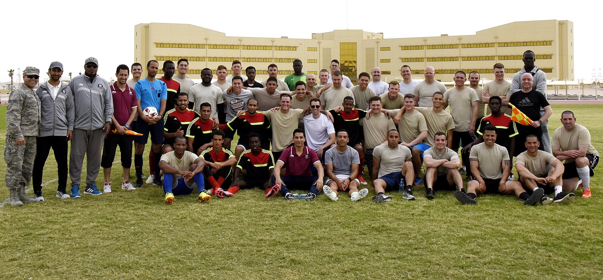 U.S. Air Force Airmen with the 379th Expeditionary Security Forces Squadron and Qatar Emiri Air Force Security Forces members pose for a photo after a friendly soccer match at Al Udeid Air Base, Qatar, March 23, 2017. The Airmen who participated in the game and those who went to support their team had the chance to interact with their host nation counterparts during the friendly match. (U.S. Air Force photo by Senior Airman Cynthia A. Innocenti)