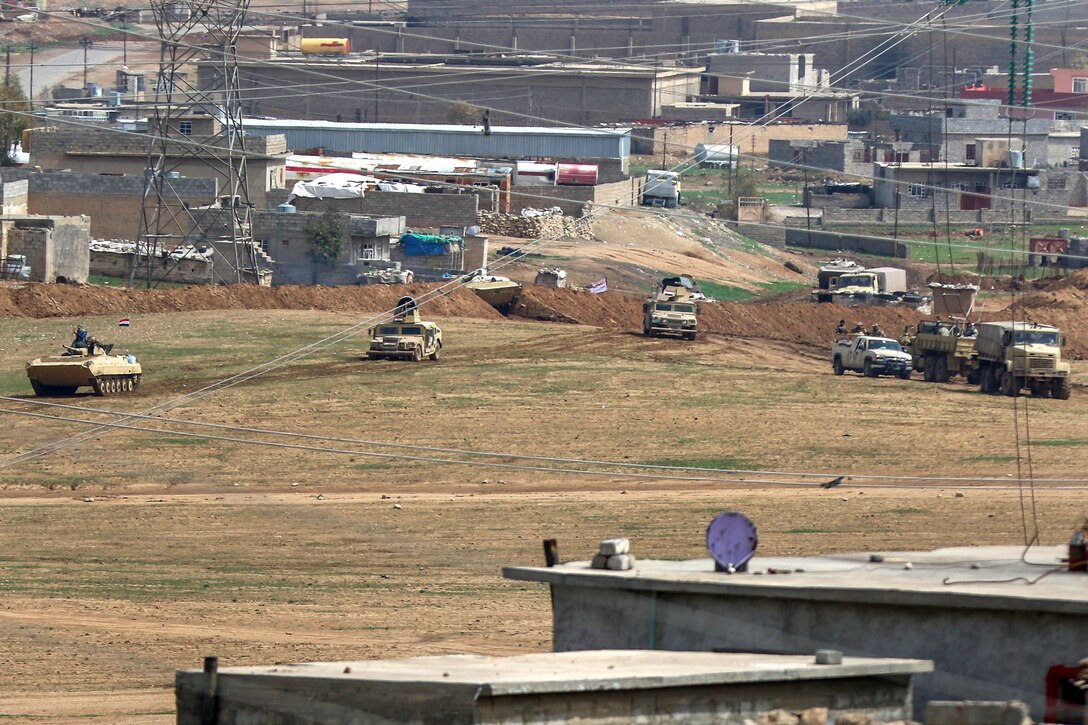 Iraqi army soldiers stage tanks and Humvees before an attack on ISIS defenses near the western edge of Mosul, Iraq, March 19, 2017. The Iraqi soldiers were supported by U.S. and Combined Joint Task Force-Operation Inherent Resolve forces. The Iraqi soldiers are assigned to the 9th Iraqi Army Division. Army photo by Staff Sgt. Jason Hull 