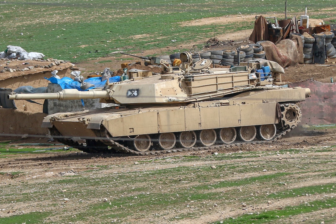 Iraqi army soldiers maneuver an M1 Abrams tank before an attack on an ISIS defenses near the western edge of Mosul, Iraq, March 19, 2017. Army photo by Staff Sgt. Jason Hull