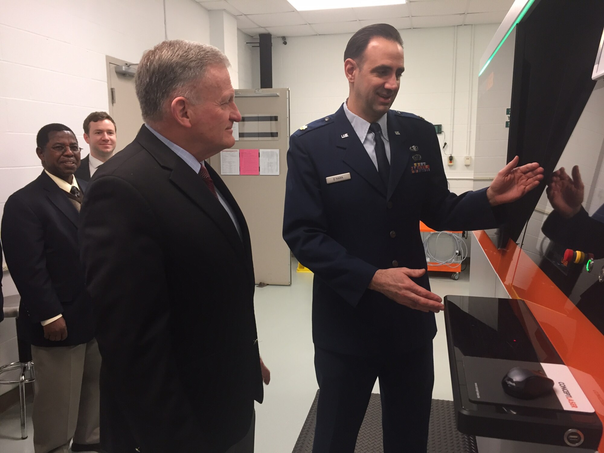 Major Ryan O’Hara (right), assistant professor, Graduate School of Engineering and Management, Air Force Institute of Technology, Wright-Patterson Air Force Base, demonstrates the capabilities of a new state-of-the-art 3D metal additive manufacturing system to Dr. Todd Stewart, AFIT director and chancellor, March 16.The system is a nearly $1 million investment that enables student researchers to digitally fabricate fully dense aerospace metal parts.(Skywrighter photo/Amy Rollins)
