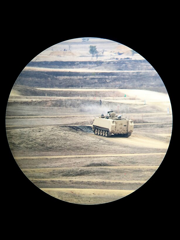 A spotting scope view of Army Reserve Combat Engineers, assigned to 366th Engineer Company, Canton New York, engage targets on a gunnery crew live-fire qualification in a M113 Armored Personnel Carrier at the Operation Cold Steel exercise at Fort McCoy, Wisconsin, Mar. 23, 2017. Operation Cold Steel is the U.S. Army Reserve’s first large-scale live-fire training and crew-served weapons qualification and validation exercise taking place from March 9 through April 25, 2017. Cold Steel is key to ensuring that America’s Army Reserve units and Soldiers are trained and ready to deploy on short-notice and bring combat-ready and lethal firepower in support of the Total Army and Joint Force partners around the world. In support of the Total Army Force, First Army Master Gunners participated in Cold Steel to provide expertise in crew level gunnery qualifications, and to develop Vehicle Crew Evaluator training, preparing units here and when they return to their home stations to conduct crew served weapons training and vehicle crew gunnery at the unit-level. 475 crews with an estimated 1,600 Army Reserve Soldiers will certify in M2, M19 and M240 Bravo crew served weapons mounted to various military vehicle platforms such as Humvees, Family of Medium Tactical Vehicles, Heavy Expanded Mobility Tactical Trucks, and Heavy Equipment Transport Systems across 12-day rotations (15 crews per cycle) through the seven-week exercise.
(U.S. Army Reserve photo by Master Sgt. Anthony L. Taylor)