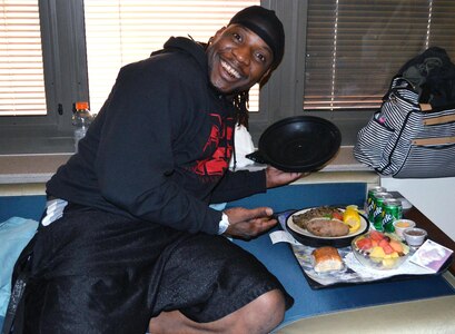 New father Trevion Johnson lifts the cover off his Proud Parent meal to reveal a steak, baked potato and corn March 14 at Brooke Army Medical Center at Joint Base San Antonio-Fort Sam Houston.