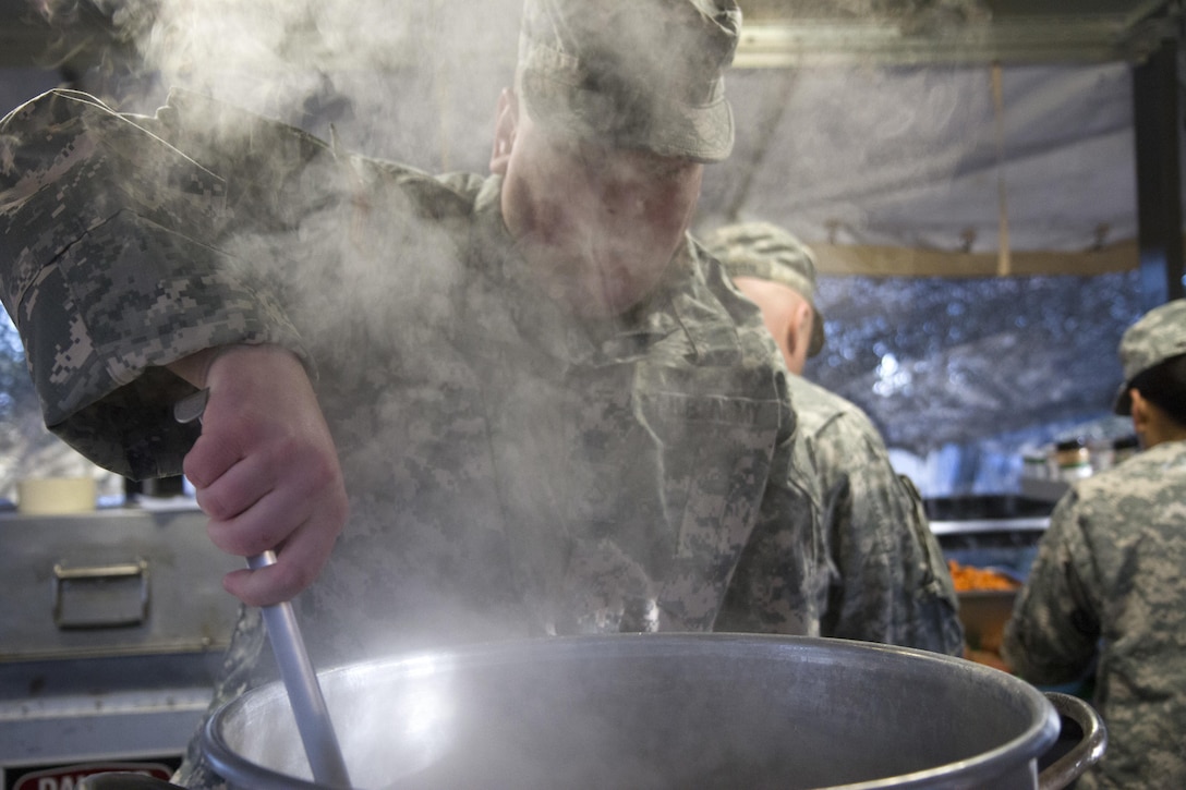 Pfc. Jordan Myers, a culinary specialist from the culinary team of the 391st Military Police Battalion, stirs the soup during food service operations in the field as part of the 49th Philip A. Connelly Award for Excellence in Army Food Service competition at Camp Blanding, Florida, March 17, 2017. The 391st MP Bn., one of four Army-wide finalists, selected Camp Blanding, Florida, as their location for the final level of testing in the competition. (U.S. Army Reserve photo by Sgt. 1st Class Carlos Lazo)