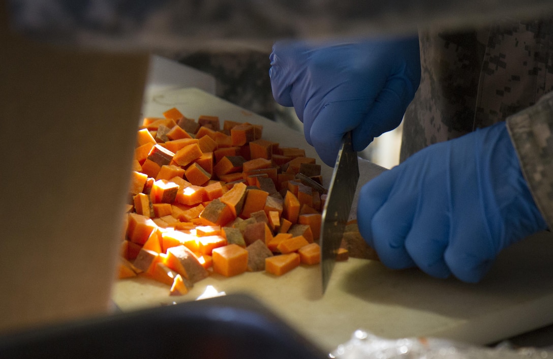 A U.S. Army Reserve Soldier from the culinary team of the 391st Military Police Battalion slices sweet potatoes during food service operations in the field as part of the 49th Philip A. Connelly Award for Excellence in Army Food Service competition at Camp Blanding, Florida, March 17, 2017. The 391st MP Bn., one of four Army-wide finalists, selected Camp Blanding, Florida, as their location for the final level of testing in the competition. (U.S. Army Reserve photo by Sgt. 1st Class Carlos Lazo)