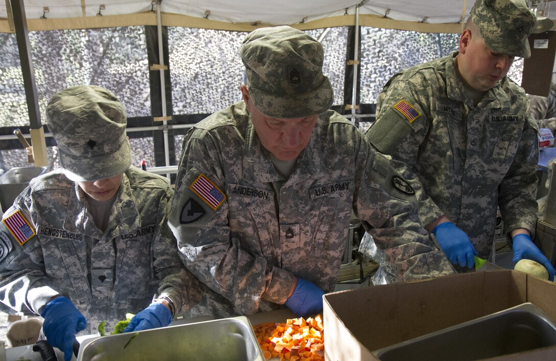 U.S. Army Reserve Soldiers from the culinary team of the 391st Military Police Battalion work in unison preparing several meals during food service operations in the field as part of the 49th Philip A. Connelly Award for Excellence in Army Food Service competition at Camp Blanding, Florida, March 17, 2017. The 391st MP Bn., one of four Army-wide finalists, selected Camp Blanding, Florida, as their location for the final level of testing in the competition. (U.S. Army Reserve photo by Sgt. 1st Class Carlos Lazo)