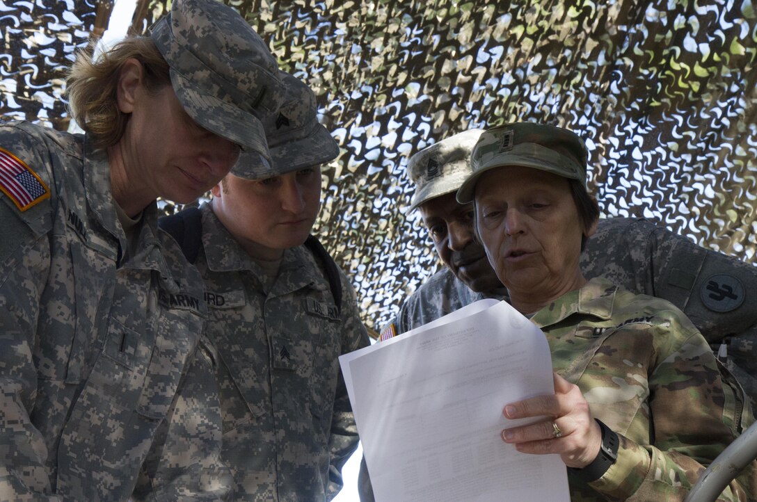 Chief Warrant Officer Kim Shiner (right), U.S. Army Reserve Command Food Service Technician, reviews the menu and inventory for the culinary team of the 391st Military Police Battalion as part of the 49th Philip A. Connelly Award for Excellence in Army Food Service competition at Camp Blanding, Florida, March 17, 2017. Shiner was one of three evaluators reviewing the 391st MP Bn.'s food service operations as part of the competition. (U.S. Army Reserve photo by Sgt. 1st Class Carlos Lazo)