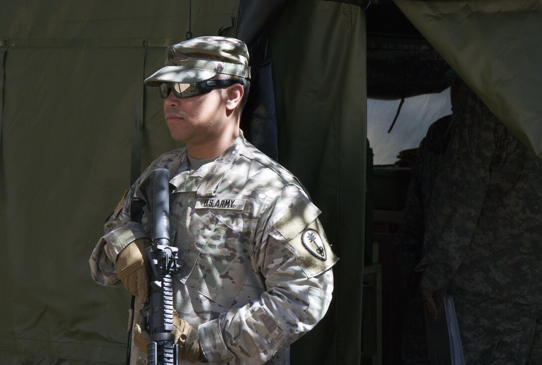 A U.S. Army Reserve Soldier from the 391st Military Police Battalion stands guard outside the dining tent during food service operations in the field as part of the 49th Philip A. Connelly Award for Excellence in Army Food Service competition at Camp Blanding, Florida, March 17, 2017. The 391st MP BN, one of four Army-wide finalists, selected Camp Blanding, Florida, as their location for the final level of testing in the competition. (U.S. Army Reserve photo by Sgt. 1st Class Carlos Lazo)