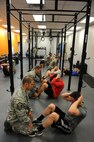 Airmen from the 5th Security Forces Squadron do sit ups as part of Global Strike Challenge tryouts at Minot Air Force Base, N.D., March 16, 2017. The tryouts pushed the defenders to their physical limits with a ruck in full gear, push-ups, pull-ups, sit-ups, buddy runs, room clearing and weapons firing.  (U.S. Air Force photo/Senior Airman Kristoffer Kaubisch)