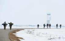 Airmen from the 5th Security Forces Squadron, ruck near the Air Traffic Control tower at Minot Air Force Base, N.D., March 16, 2017. The ruck was one of the many requirements for the Global Strike Challenge tryouts for the 5 SFS. (U.S. Air Force photo/Senior Airman Kristoffer Kaubisch)