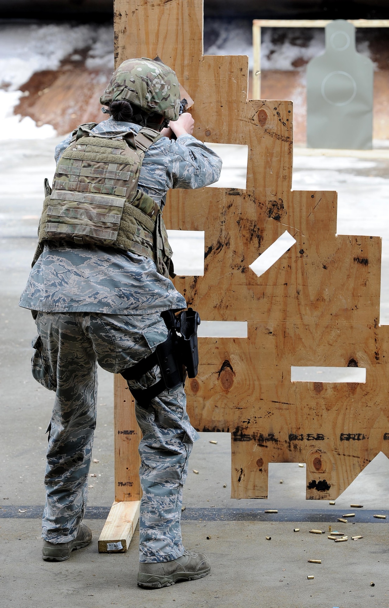 Senior Airman Amanda Gordon, 5th Security Forces Squadron defender, shoots a M9 pistol at a target for Global Strike Challenge tryouts at Minot Air Force Base, N.D., March 16, 2017. The 9 hole board teaches defenders how to shoot in different positions. (U.S. Air Force photo/Senior Airman Kristoffer Kaubisch)