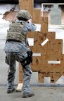 Senior Airman Amanda Gordon, 5th Security Forces Squadron defender, shoots a M9 pistol at a target for Global Strike Challenge tryouts at Minot Air Force Base, N.D., March 16, 2017. The 9 hole board teaches defenders how to shoot in different positions. (U.S. Air Force photo/Senior Airman Kristoffer Kaubisch)