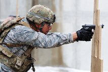 1st Lt. Kevin Aguilar, 5th Security Forces Squadron defender, shoots a M9 pistol at a target for Global Strike Challenge tryouts at Minot Air Force Base, N.D., March 16, 2017. The defenders were timed during their tryouts at the shooting range. (U.S. Air Force photo/Senior Airman Kristoffer Kaubisch)