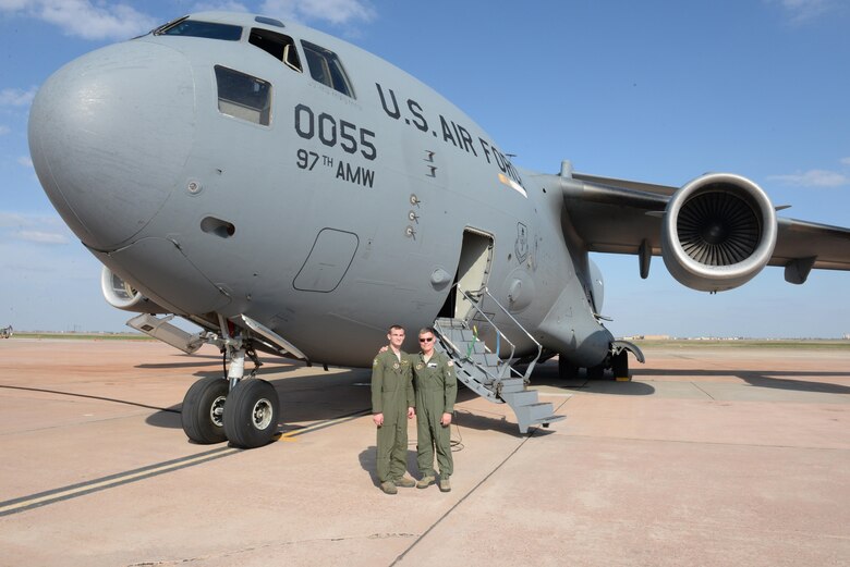 U.S. Air Force Senior Airman Brendin Peters (left), 317th Airlift Squadron loadmaster and U.S. Air Force Col. Craig Peters, 940th Air Refueling Wing commander, reunite in front of a U.S. Air Force C-17 Globemaster III cargo aircraft after a training mission, March 17, 2017, at Altus Air Force Base, Oklahoma. Brendin Peters participated in a refueling training mission where his crew’s C-17 was refueled by a U.S. Air Force KC-135 Stratotanker refueling aircraft piloted by his father Craig Peters. (U.S. Air Force photo by Airman 1st Class Cody Dowell/Released)

