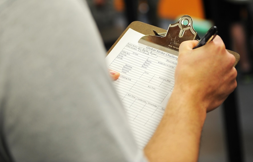 Airman 1st Class Bryan Butler, 5th Security Forces Squadron defender, fills out a form for Global Strike Challenge tryouts at Minot Air Force Base, N.D., March 16, 2017. The tryouts pushed the defenders to their physical limits with a ruck in full gear, push-ups, pull-ups, sit-ups, buddy runs, room clearing and weapons firing.  (U.S. Air Force photo/Senior Airman Kristoffer Kaubisch)