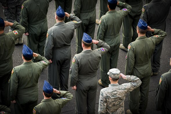 Members of the 374th Operations Group salute during a retreat ceremony March 17, 2017, at Yokota Air Base, Japan. The retreat ceremony serves as a way to pay respect to the flag and signals the end of the official duty day with the playing of the national anthem while lowering and folding the flag. (U.S. Air Force photo/Airman 1st Class Donald Hudson)