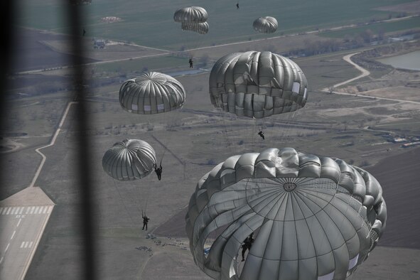 Bulgarian paratroopers descend from a C-130J Super Hercules during Exercise Thracian Spring 17 at Plovdiv Regional Airport, Bulgaria, March 20, 2017. Airmen from the 37th Airlift Squadron, 435th Contingency Response Group, and 86th Airlift Wing, Ramstein Air Base, Germany, partnered with the Bulgarian military for the two-week exercise. The U.S. Air Force’s forward presence in Europe allows Airmen to work hand-in-hand with Allies to develop and improve ready air forces that are capable of maintaining regional security.  (U.S. Air Force photo by Staff Sgt. Nesha Humes)