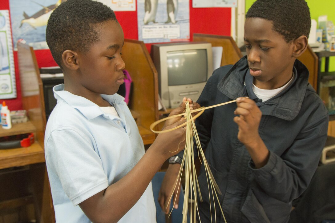 Students from Miracle Academy wove sweetgrass discs with sweetgrass from the Charleston District's Cooper River Rediversion Project, which were hung around a sweetgrass cross at Mother Emanuel AME Church.