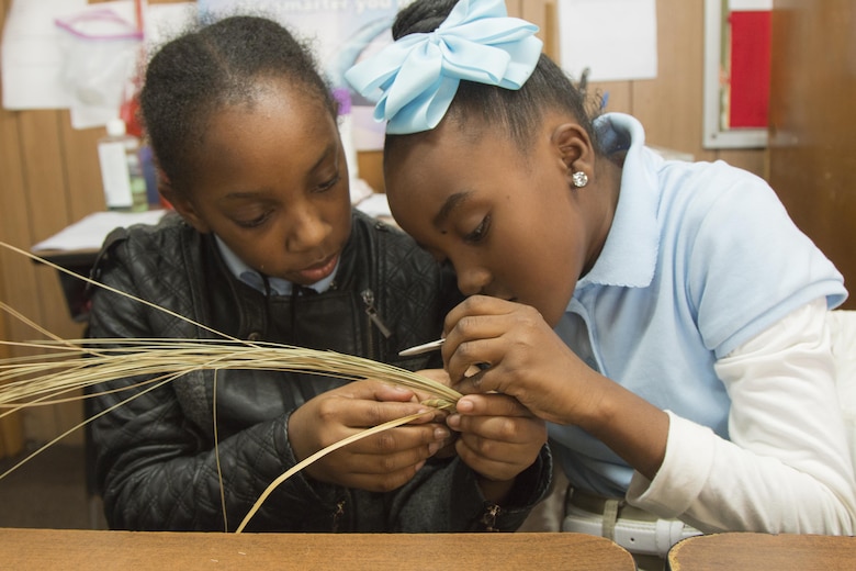 Students from Miracle Academy wove sweetgrass discs with sweetgrass from the Charleston District's Cooper River Rediversion Project, which were hung around a sweetgrass cross at Mother Emanuel AME Church.