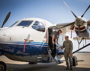 Dale Rice exits a C-145A Skytruck while talking with Maj. Terrell Eikner, the 919th Aircraft Maintenance Squadron commander, during the Crestview Military Affairs Committee’s tour of Duke Field, Fla., March 23.  (U.S. Air Force photo/Tech. Sgt. Samuel King Jr.)