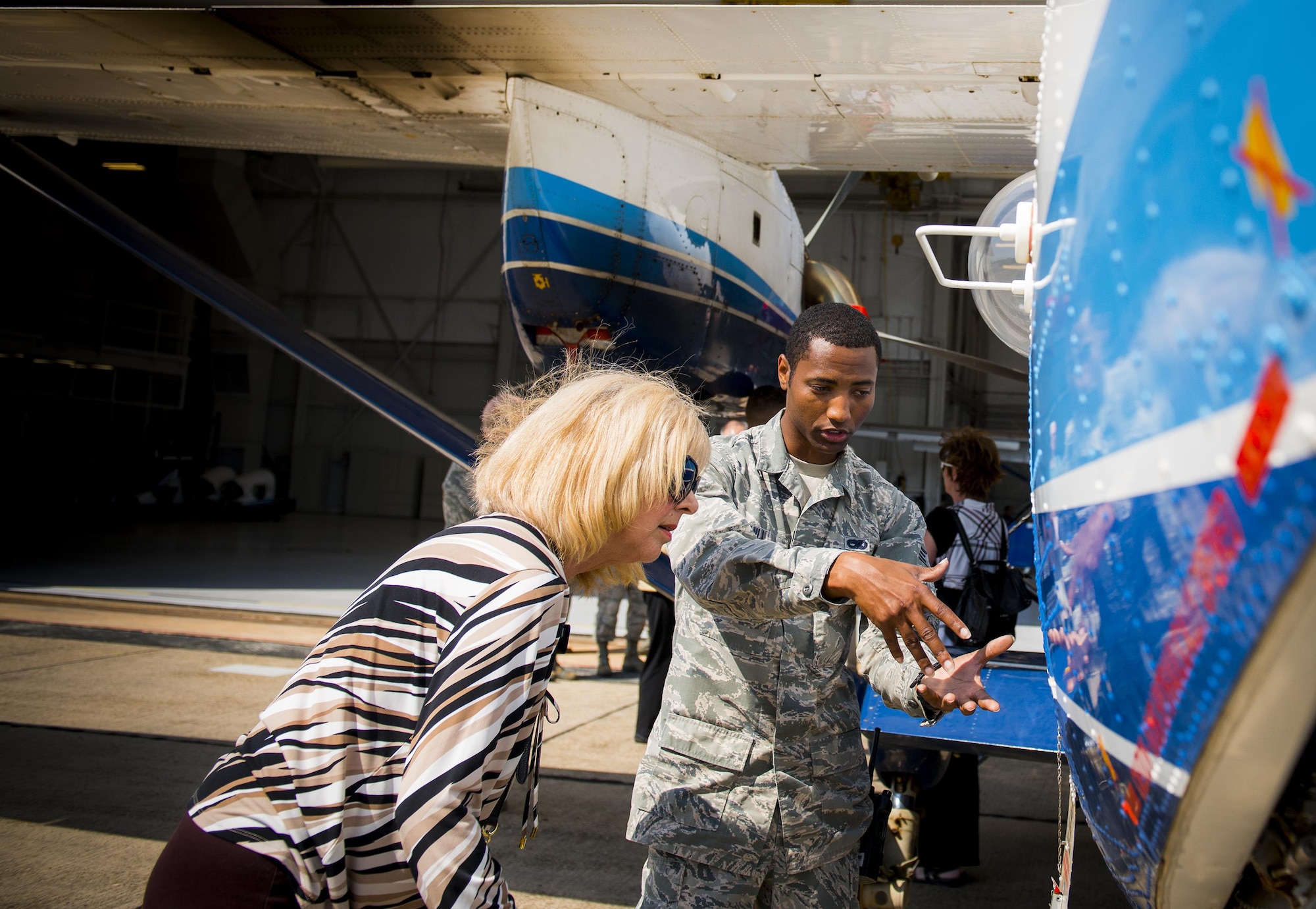 Senior Airman Mario Hill, 919th Aircraft Maintenance Squadron, explains how the C-145A Skytruck is refueled to Marian McBryde, a Crestview Military Affairs Committee member, during their tour of Duke Field, Fla., March 23.  (U.S. Air Force photo/Tech. Sgt. Samuel King Jr.)