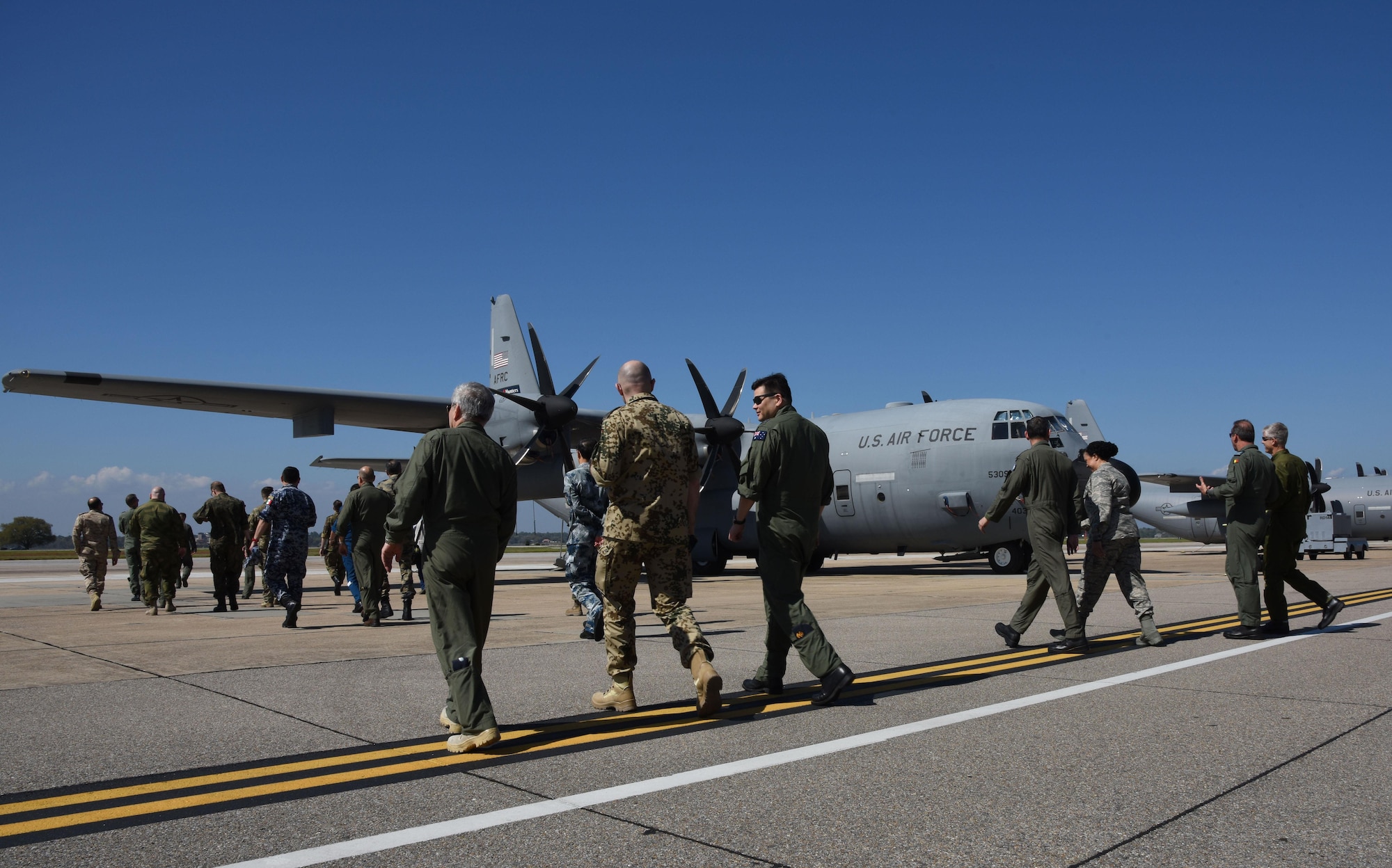 Air Attaché members walk toward a WC-130 Hercules for a tour during an Air Attaché visit March 20, 2017, on Keesler Air Force Base, Miss. The visit provided diplomatically accredited attachés with an overview of industrial, cultural and social aspects of the U.S. military and develop cordial relations amongst international attachés. (U.S. Air Force photo by Kemberly Groue)