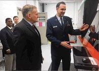Maj. Ryan O'Hara (right), assistant professor, Graduate School of Engineering and Management, Air Force Institute of Technology, Wright-Patterson Air Force Base, demonstrates the capabilities of a new state-of-the-art 3D metal additive manufacturing system to Dr. Todd Stewart, AFIT director and chancellor, March 16.The system is a nearly $1 million investment that enables student researchers to digitally fabricate fully dense aerospace metal parts.(Skywrighter photos/Amy Rollins)