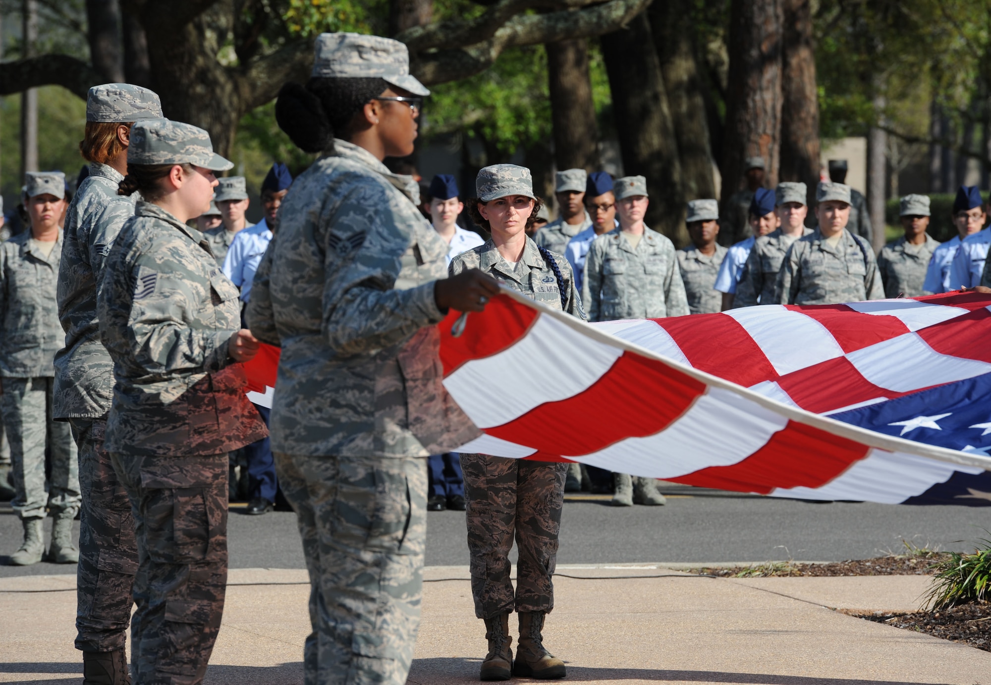 Master Sgt. Amber Pacheco, 81st Training Group Air National Guard liaison, participates in a flag folding ceremony during a Women’s History Month all-female retreat ceremony March 21, 2017, on Keesler Air Force Base, Miss. The theme of 2017 WHM is “Honoring Trailblazing Women in Labor and Business” to honor women who have successfully challenged the female role in business and the paid labor force (U.S. Air Force photo by Kemberly Groue)