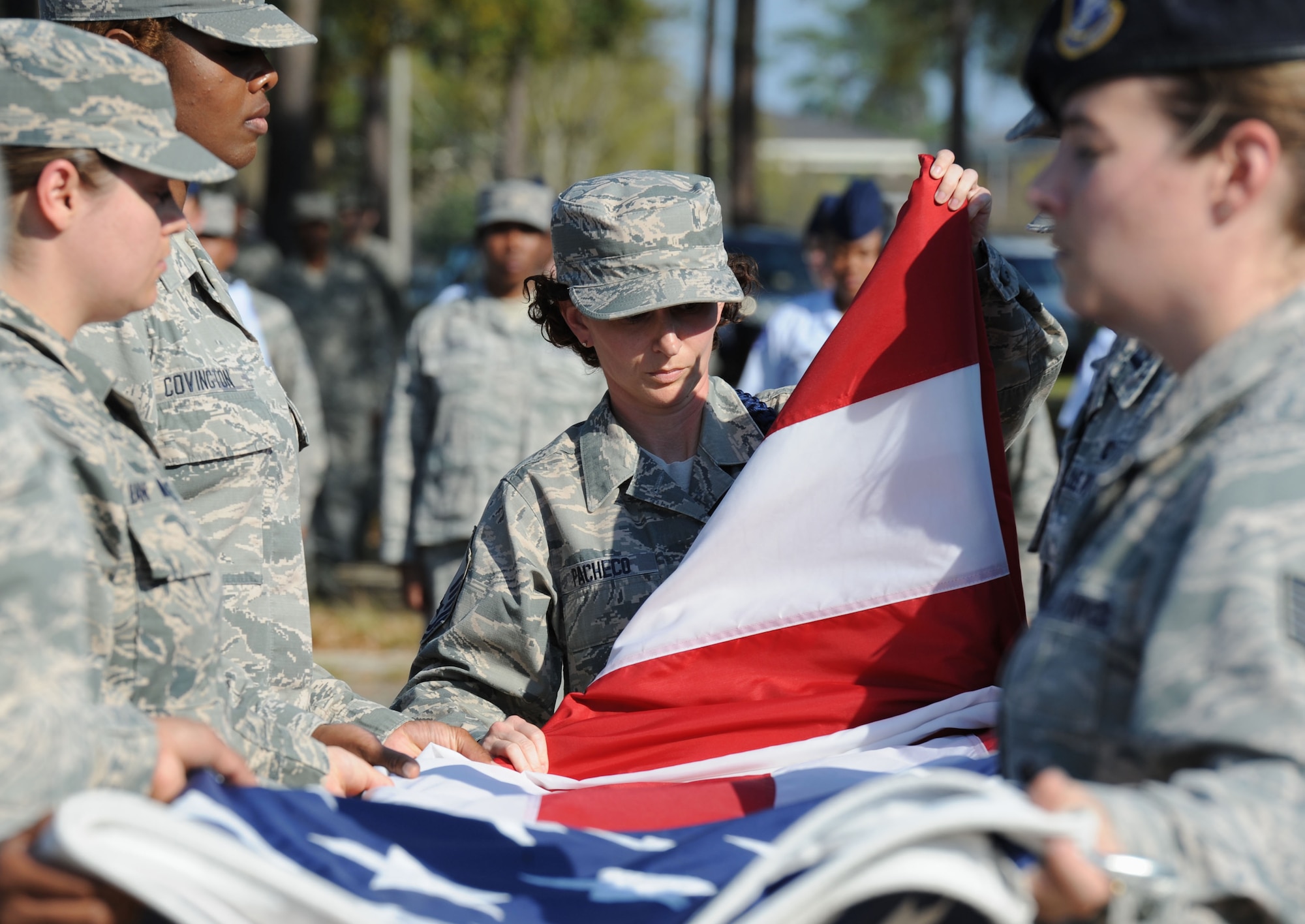 Master Sgt. Amber Pacheco, 81st Training Group Air National Guard liaison, folds the U.S. flag during a Women’s History Month all-female retreat ceremony March 21, 2017, on Keesler Air Force Base, Miss. The theme of 2017 WHM is “Honoring Trailblazing Women in Labor and Business” to honor women who have successfully challenged the female role in business and the paid labor force. (U.S. Air Force photo by Kemberly Groue)