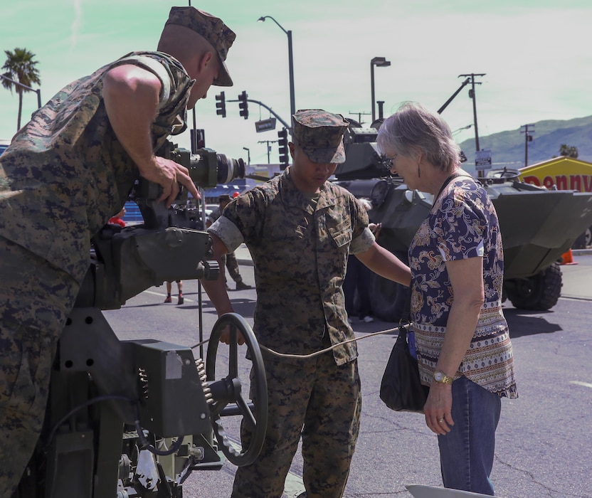 Marines explain the mechanics of a Light Armored Vehicle to a Twentynine Palms resident during the 17th annual Car Show & Street Fair in Twentynine Palms, California.