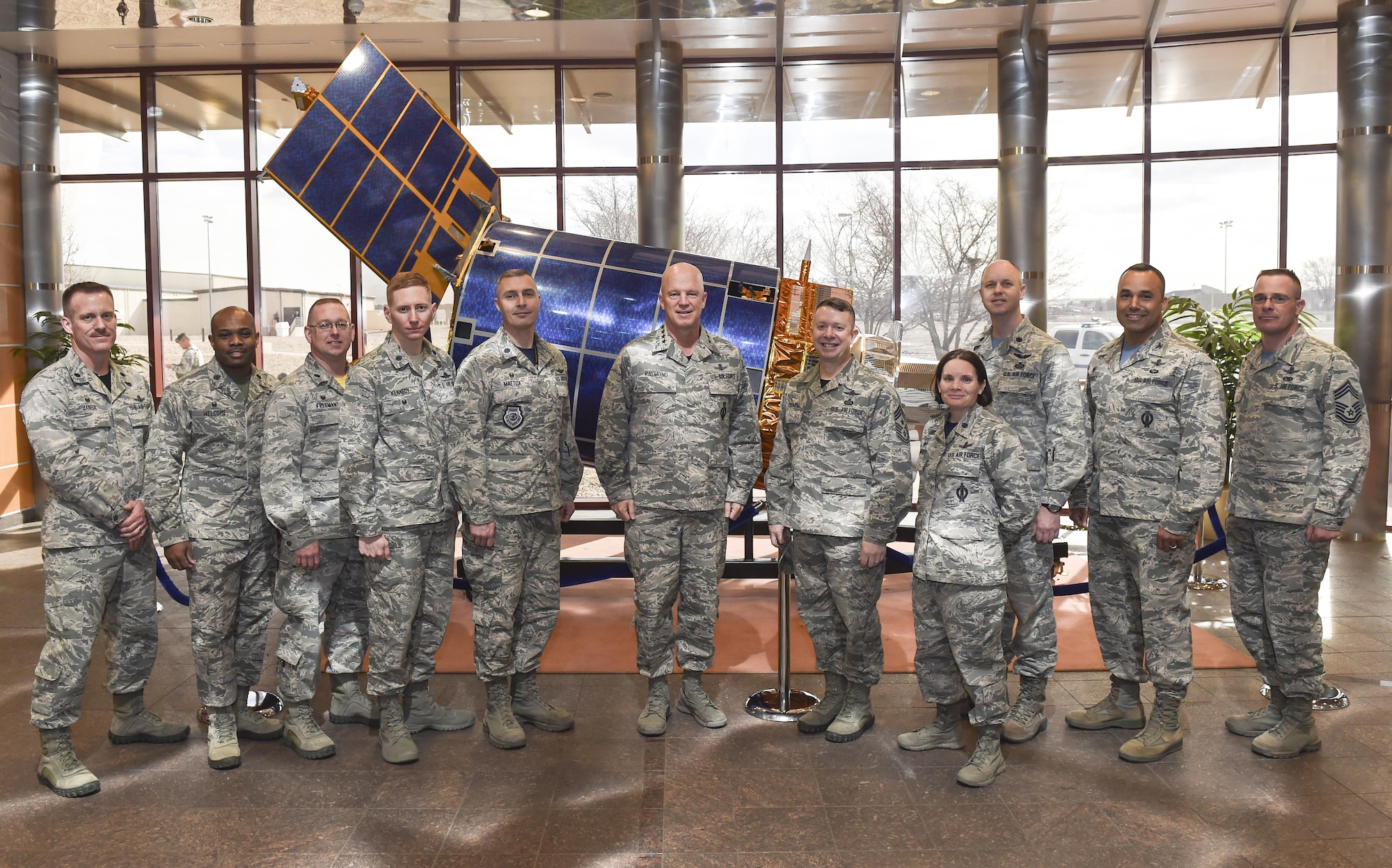 Gen. Jay Raymond, commander of Air Force Space Command, center, and Chief Master Sgt. Brendan Criswell, AFSPC command chief, poses with Team Buckley leadership cadre in front of a Defense Support Program half-scale satellite March 17, 2017, at Buckley Air Force Base, Colo. Buckley boasts America’s Premier Space Wing, installation support to 95 multiservice and multinational units, a population of over 94,000 Team Buckley members, and a mission that is critical to the nation’s safety. (U.S. Air Force photo by Tech. Sgt. Nicholas Rau)