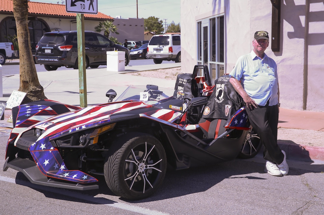 Retired Army Vietnam veteran Mike Hammer shows off his Puller Slingshot car painted as the American flag car during the 17th annual Car Show & Street Fair in Twentynine Palms, Calif., March 18, 2017. The Twentynine Palms Chamber of Commerce hosted the event to bring the community together. (U.S. Marine Corps photo by Lance Cpl. Natalia Cuevas)