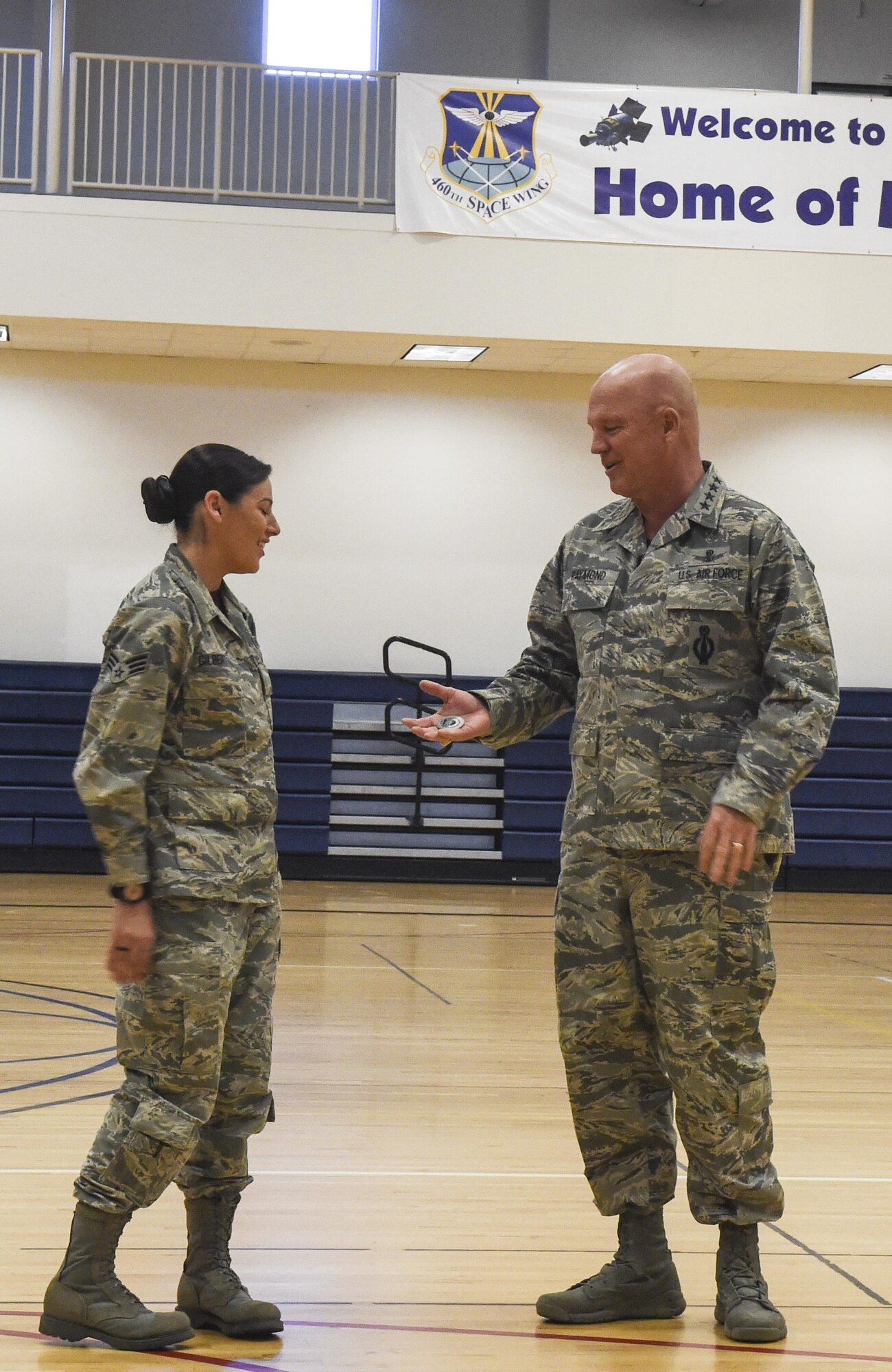Senior Airman Sarah Gilbert, 460th Medical Group public health, left, receives a coin from Gen. Jay Raymond, commander of Air Force Space Command, for excellence March 17, 2017, at Buckley Air Force Base, Colo. Buckley boasts America’s Premier Space Wing, installation support to 95 multiservice and multinational units, a population of over 94,000 Team Buckley members, and a mission that is critical to the nation’s safety. (U.S. Air Force photo by Tech. Sgt. Nicholas Rau)