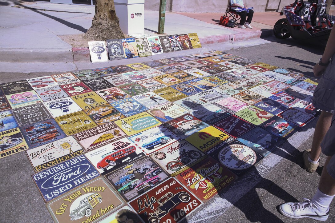 Vendors sell bumper stickers during the 17th annual Car Show & Street Fair in Twentynine Palms, Calif., March 18, 2017. The Twentynine Palms Chamber of Commerce hosted the event to bring the community together. (U.S. Marine Corps photo by Lance Cpl. Natalia Cuevas)