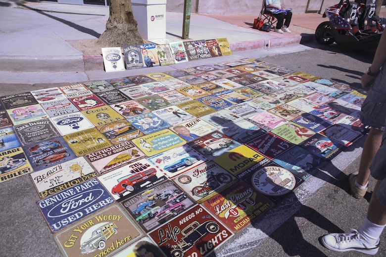 Vendors sell bumper stickers during the 17th annual Car Show & Street Fair in Twentynine Palms, Calif., March 18, 2017. The Twentynine Palms Chamber of Commerce hosted the event to bring the community together. (U.S. Marine Corps photo by Lance Cpl. Natalia Cuevas)