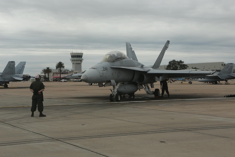 A Marine with Marine Fighter Attack Training Squadron (VMFAT) 101, 3rd Marine Aircraft Wing prepares an F/A-18 Hornet for taxi at Marine Corps Air Station Miramar, Calif., March 21. VMFAT-101 is the largest F/A-18 squadron in the Marine Corps and has over 60 fighter jets attached to the squadron. (U.S. Marine Corps photo by Lance Cpl. Liah Kitchen/Released)