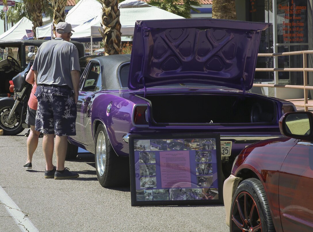 Community members look inside an antique car during the 17th annual Car Show & Street Fair in Twentynine Palms, Calif., March 18, 2017. The Twentynine Palms Chamber of Commerce hosted the event to bring the community together. (U.S. Marine Corps photo by Lance Cpl. Natalia Cuevas)