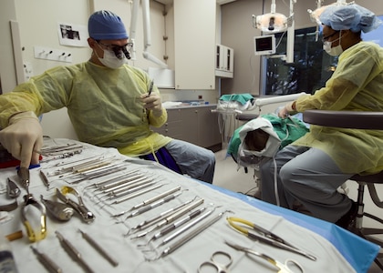 Senior Airman Vanessa Powell-Davis, right, 59th Dental Training Squadron periodontics technician, prepares a patient for periodontal surgery performed by Capt. Andrew Verrett, a 59th DTS periodontics resident, at the Air Force Postgraduate Dental School, Joint Base San Antonio-Lackland, Texas. The wing’s postgraduate medical education function provides a wide array of training programs ranging from general surgery to emergency medical services administration. (U.S. Air Force photo/Staff Sgt. Kevin Iinuma)